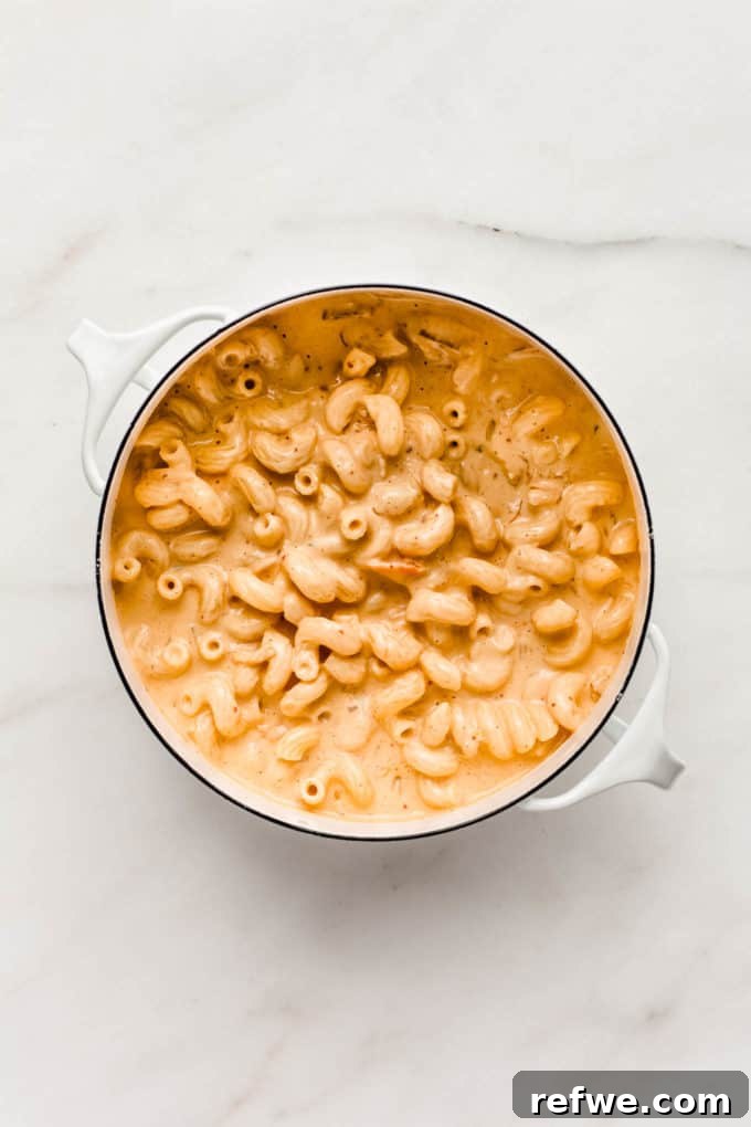 Korean Fusion Vegan Mac and Cheese 5 Another view of the delicious vegan kimchi mac and cheese being mixed, highlighting its appetizing appearance