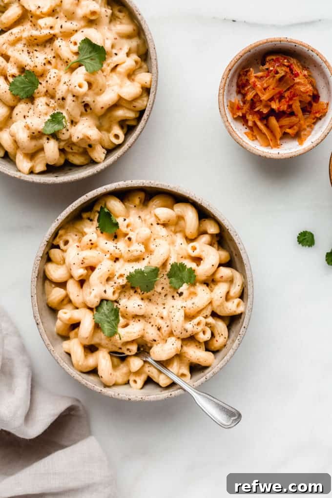 Korean Fusion Vegan Mac and Cheese 6 Two bowls of inviting vegan kimchi mac and cheese, garnished with fresh kimchi, ready to be served