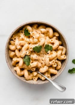 A top down view of a bowl of vegan mac and cheese noodles in a creamy sauce