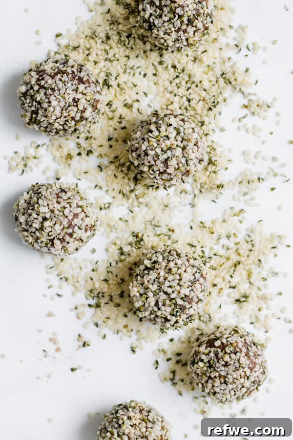 Two almond butter energy bites coated in shredded coconut