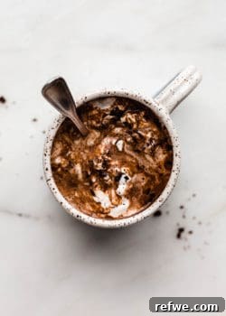 A mug of hot chocolate with a spoon in it