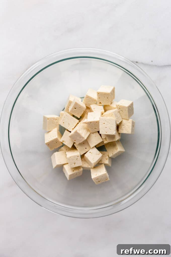 Caramelized Tofu 4 cubes of tofu in a mixing bowl