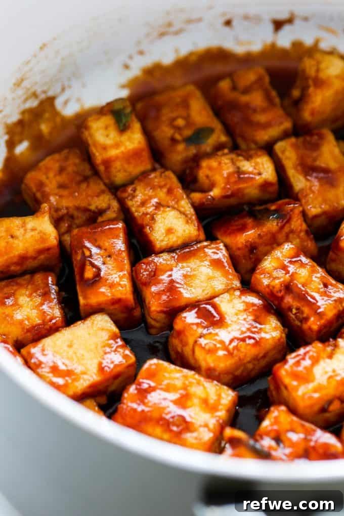 Caramelized Tofu 7 a close up of cubed tofu in sesame sauce in a pan