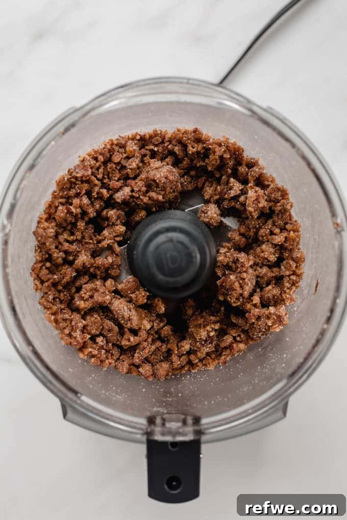Wholesome Chocolate Turtles 4 A food processor bowl showing the Medjool dates after being blended into a crumbly dough