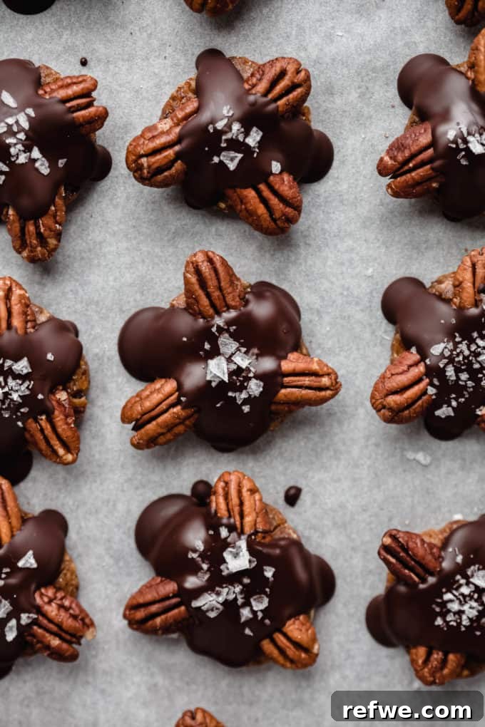 Wholesome Chocolate Turtles 9 healthy chocolate turtle candies neatly arranged on a baking sheet with parchment paper