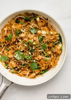 Spaghetti squash and vegetables in a white pan, indicating a prepared dish