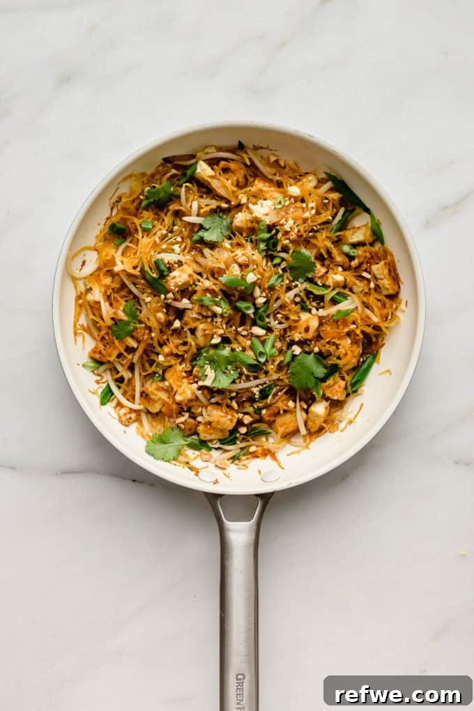 Squash Noodle Pad Thai 7 A white pan featuring a generous serving of spaghetti squash pad Thai, garnished and ready