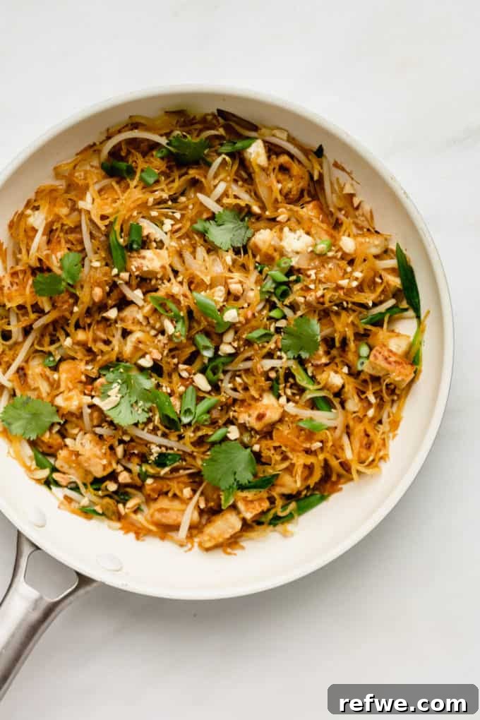 Squash Noodle Pad Thai 8 Close-up of spaghetti squash and mixed vegetables in a white pan, showcasing texture and color