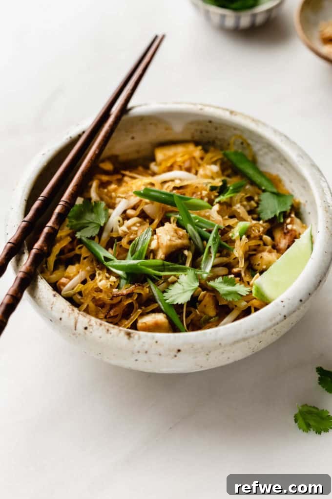 Squash Noodle Pad Thai 9 A beautifully presented bowl of spaghetti squash pad Thai, generously topped with sliced green onions and a sprinkle of cilantro