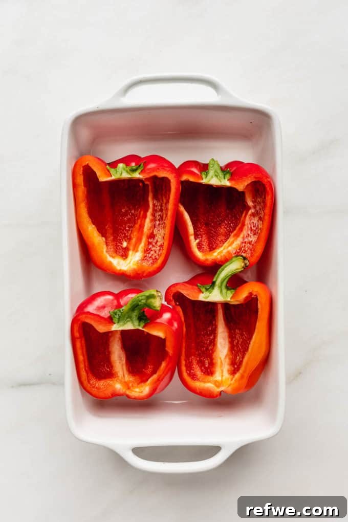 Wholesome Quinoa & Veggie Stuffed Peppers 3 2 red bell peppers slice in half in a white baking dish