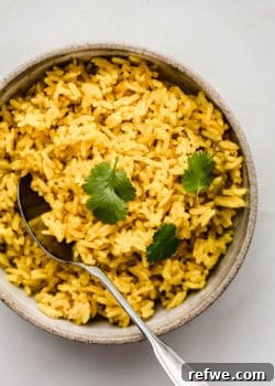 A bowl of turmeric rice topped with cilantro