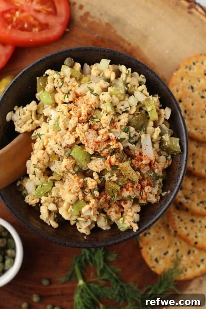 Unlock Tempeh's Potential 23 Recipes and a Full Cooking Guide 21 A sleek black bowl filled with a creamy, delectable Tempeh Tuna Salad, garnished and ready for a refreshing lunch or snack.