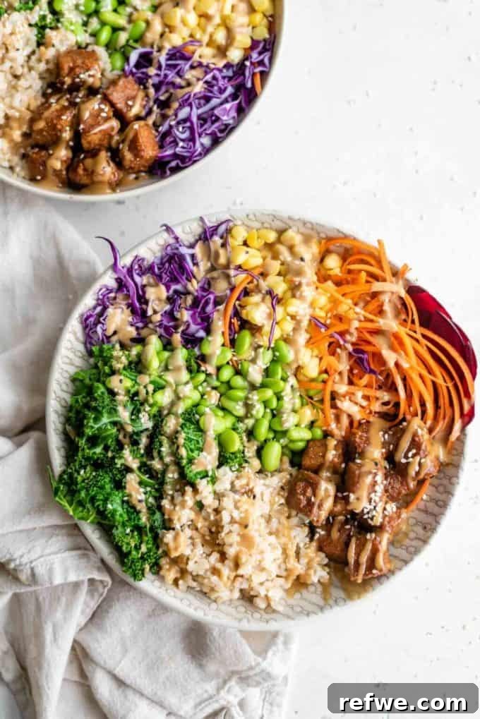 Unlock Tempeh's Potential 23 Recipes and a Full Cooking Guide 23 A colorful Buddha bowl generously filled with brown rice, an assortment of fresh vegetables, and delectable soy sauce and peanut butter marinated tempeh.