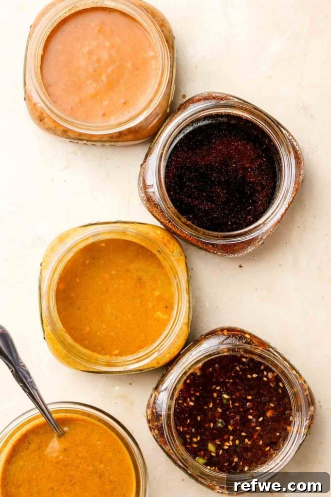 Unlock Tempeh's Potential 23 Recipes and a Full Cooking Guide 24 Five glass jars showcasing a variety of vibrant and delicious marinades specifically crafted for tempeh, including Tandoori, Smoky Maple, Satay, Korean BBQ, and Spiced Yogurt.