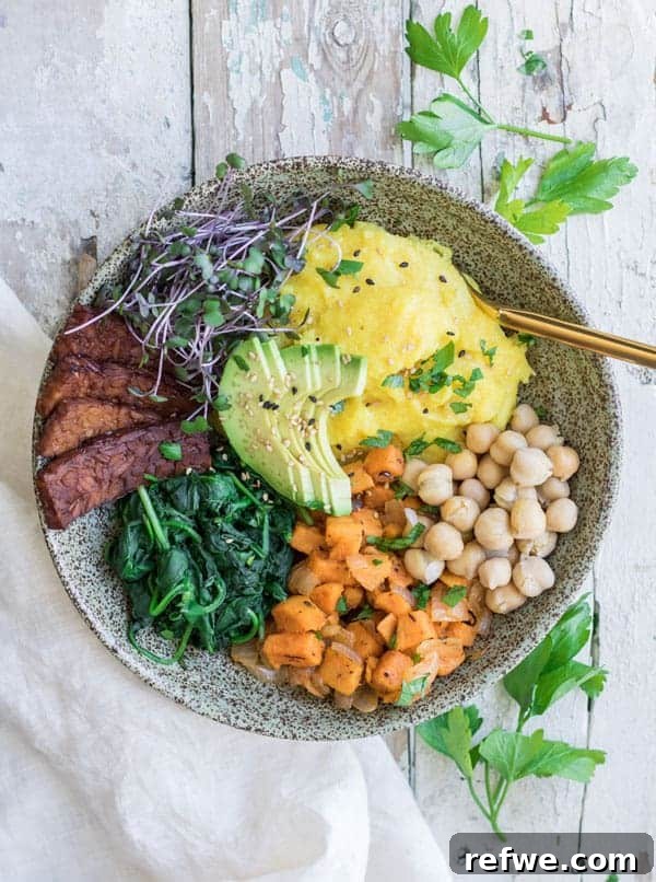 Unlock Tempeh's Potential 23 Recipes and a Full Cooking Guide 4 A hearty vegan breakfast bowl featuring creamy polenta, crispy tempeh bacon, and roasted vegetables, beautifully arranged.