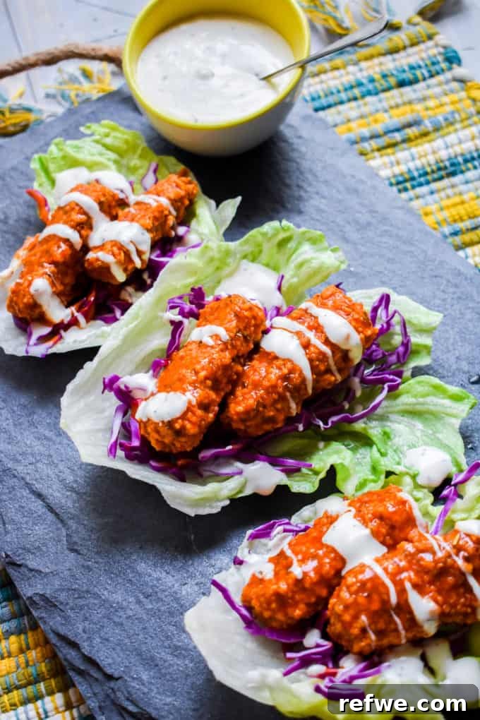 Unlock Tempeh's Potential 23 Recipes and a Full Cooking Guide 8 Crispy panko-crusted buffalo tempeh nestled in vibrant lettuce cups, ready to be enjoyed as a low-carb taco.