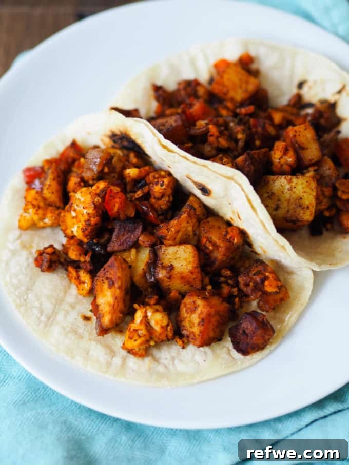 Unlock Tempeh's Potential 23 Recipes and a Full Cooking Guide 9 Flavorful vegan chorizo and potato filling generously stuffed into warm taco shells, topped with fresh cilantro.