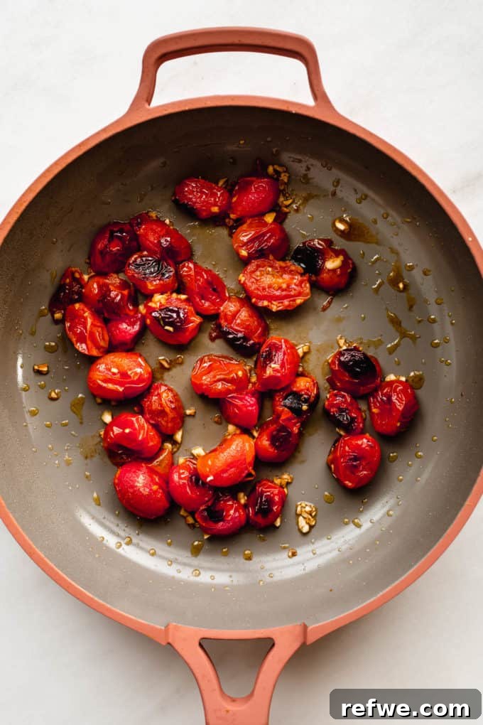 Sun-Drenched Mediterranean Pasta 3 Roasted cherry tomatoes and garlic sizzling in a pan