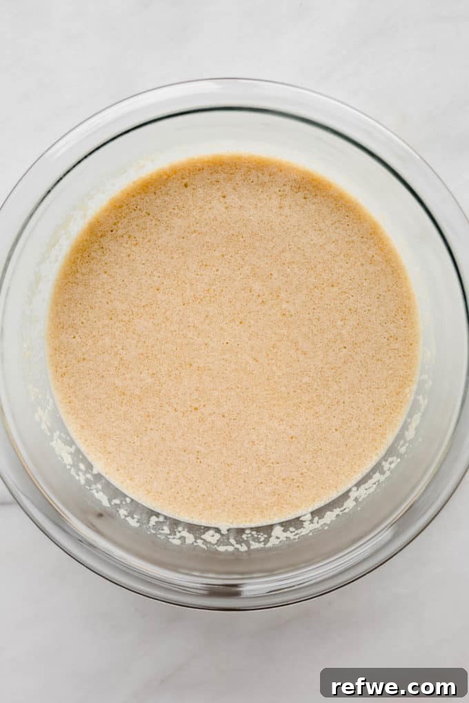 A bowl of almond milk and eggs being whisked together, ready for the baked oatmeal recipe.