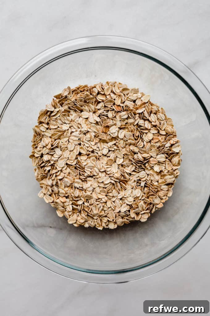 A bowl of rolled oats with cinnamon and coconut sugar, ready to be mixed for baked oatmeal.