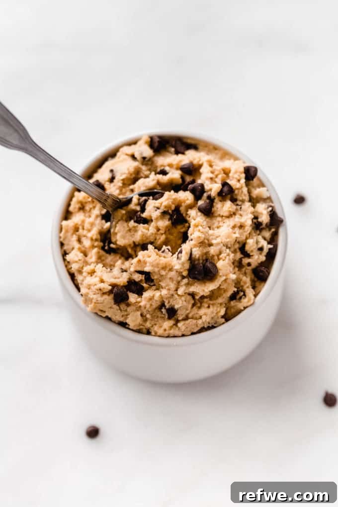 Creamy Almond Chickpea Cookie Dough 7 chickpea cookie dough in a small white bowl with a spoon in it