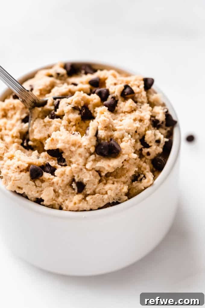 Creamy Almond Chickpea Cookie Dough 8 a close up of chocolate chip chickpea cookie dough in a small white bowl