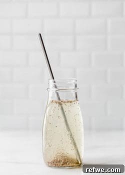 a chia seed drink in a jar with a metal straw