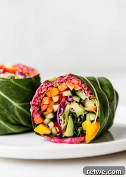 A rainbow collard green wrap on a white plate
