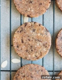 Stacked no-bake chocolate chip almond cookies on a plate, ready to eat