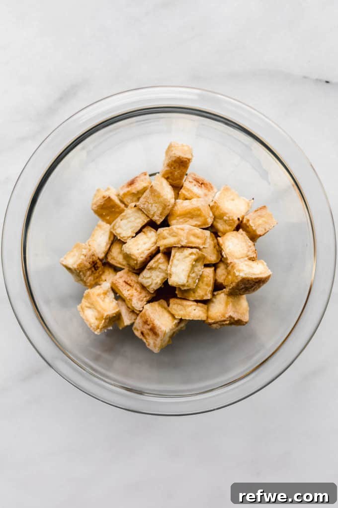 Sticky Teriyaki Glazed Crispy Tofu 5 Baked crispy tofu in a clear bowl