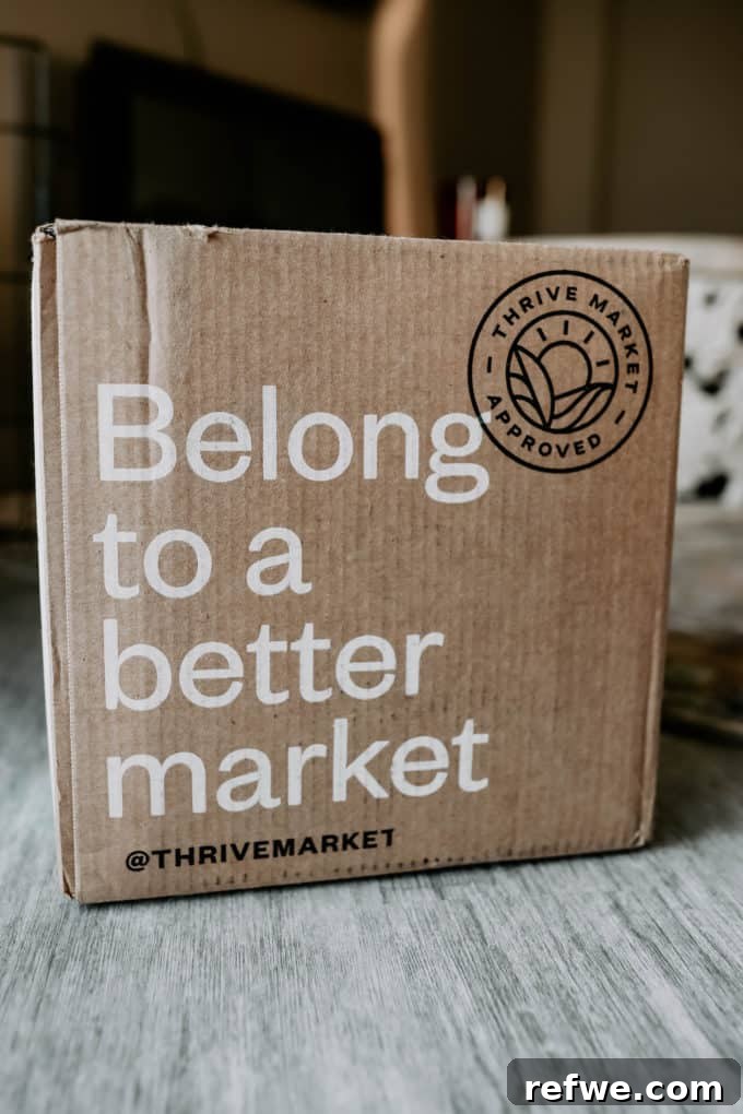 Thrive Market 2021 Is It Worth Your Money 8 A Thrive Market delivery box made of cardboard, featuring the brand's logo and eco-friendly packaging materials.