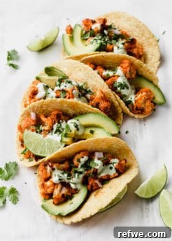 buffalo cauliflower tacos with cilantro sauce and cilantro on top