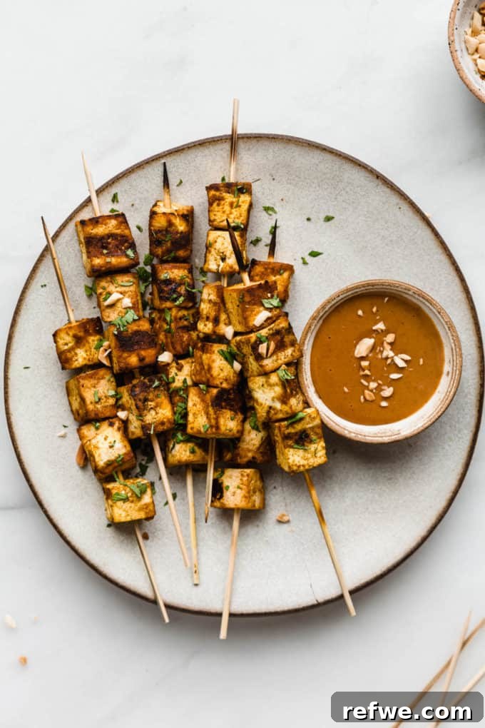 Grilled Tofu Satay with Creamy Peanut Sauce 7 Close-up of perfectly grilled Tofu Satay skewers, showcasing their golden-brown char and succulent texture.