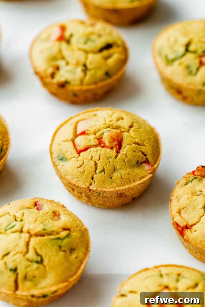 A single, perfectly formed chickpea flour mini quiche sitting on a clean white kitchen counter, highlighting its appealing texture and simplicity.