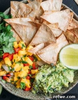 Baked corn chips with guacamole and mango salsa