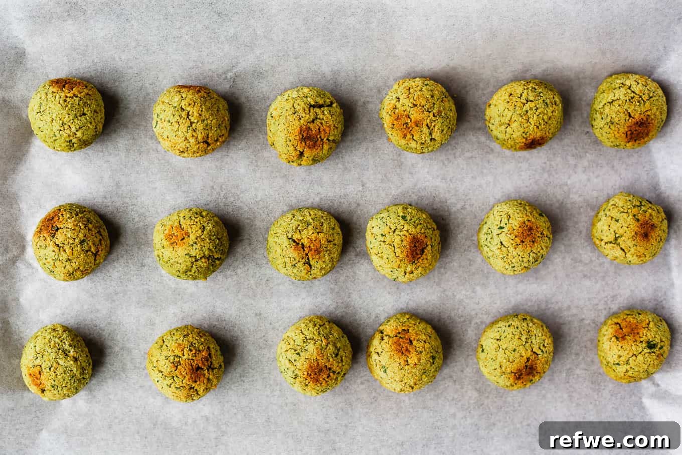 Crispy Oven-Baked Vegan Falafel 13 baked falafel balls on a baking sheet