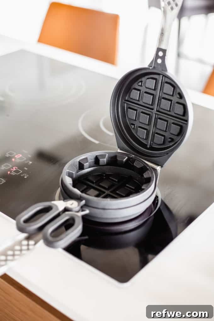 Snickers Banana Bliss Waffles 3 An open Wonderffle waffle iron resting on a stove burner, ready for batter.