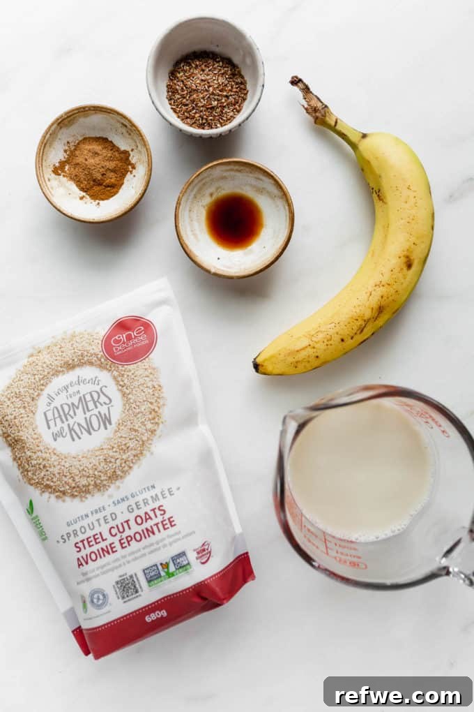 Liquid Banana Bread 3 A flat lay of fresh ingredients laid out for making a banana bread smoothie, including bananas, oats, cinnamon, nutmeg, vanilla, and almond milk.