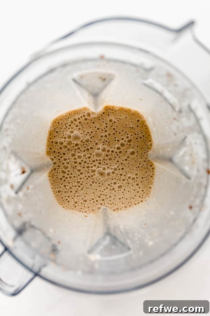 Liquid Banana Bread 5 The banana bread smoothie blending in a high-speed blender, creating a smooth and creamy texture.