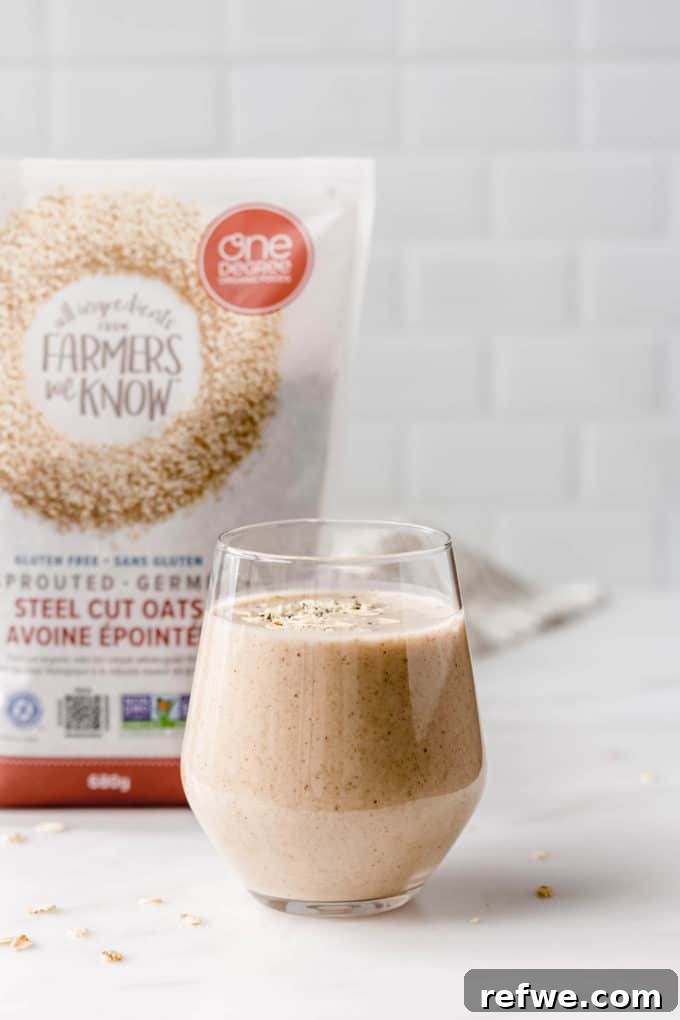 Liquid Banana Bread 6 A tall glass of banana bread smoothie, with a package of steel cut oats in the background, highlighting the key ingredient.
