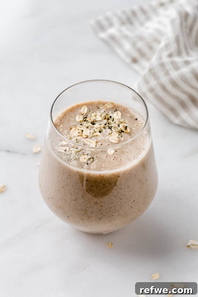 Liquid Banana Bread 7 A banana bread smoothie garnished with a sprinkle of oats on top, ready to be enjoyed.