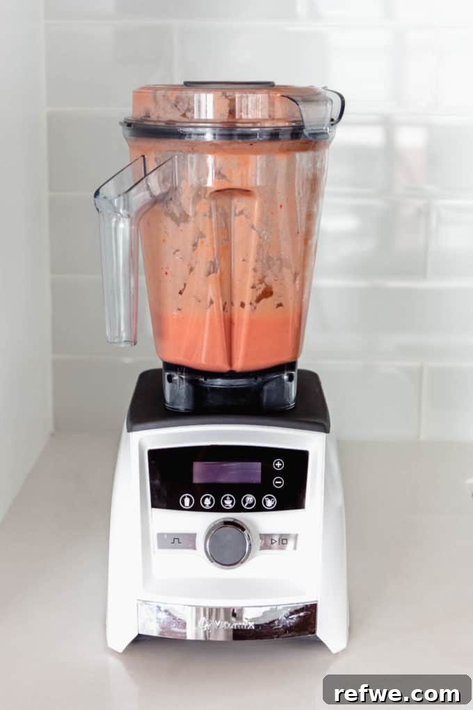 Tropical Strawberry Mango Delight 4 All the strawberry mango smoothie ingredients are loaded into a blender, ready to be processed.