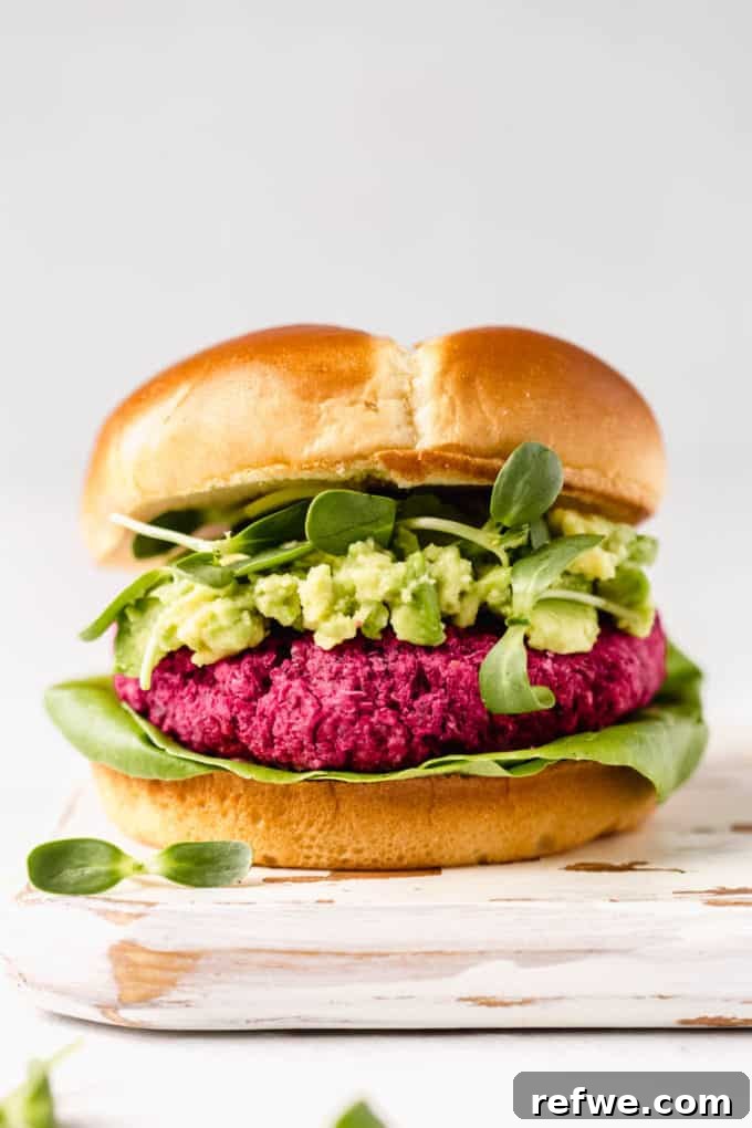 Vibrant Vegan Beet Burgers 7 A vibrant and healthy vegan beet burger served on a soft bun with fresh avocado, crunchy sprouts, and crisp lettuce.