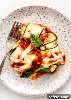 Zucchini involtini on a white speckled plate
