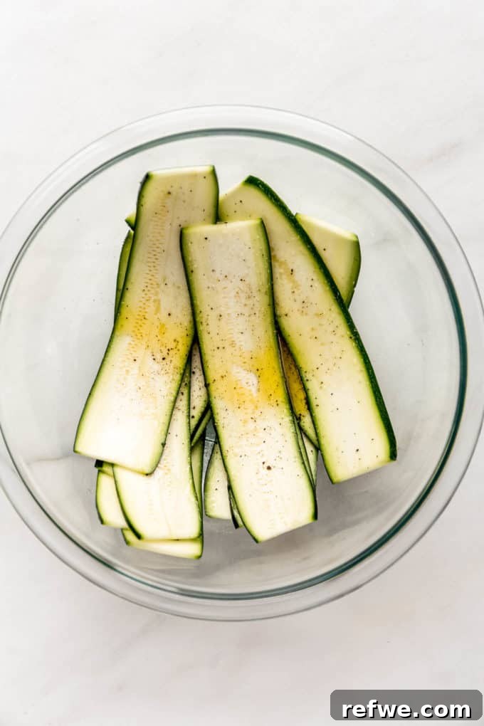 Creamy Ricotta Zucchini Pinwheels 4 Zucchini with olive oil in a mixing bowl