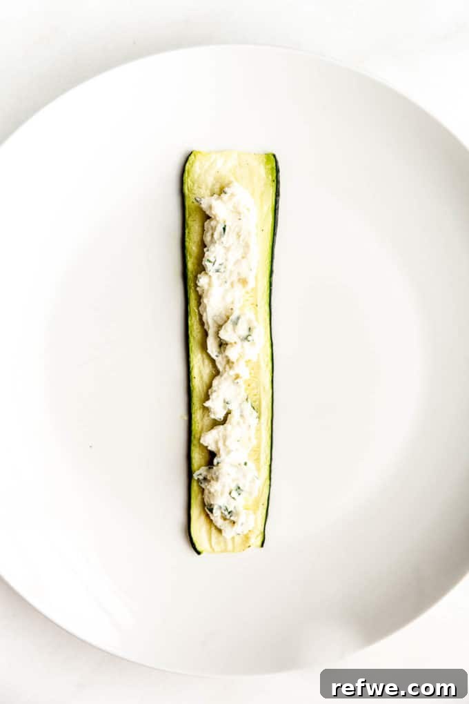 Creamy Ricotta Zucchini Pinwheels 7 A slice of zucchini with ricotta spread in the centre