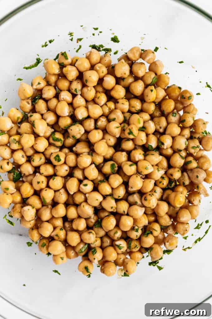 Infused Chickpea Bites 5 A close-up view of perfectly seasoned and marinated chickpeas nestled in a bowl, gleaming and ready to be devoured.