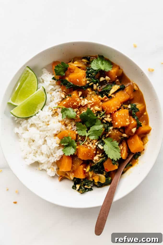 Velvet Squash Curry 11 A bowl of butternut squash curry, beautifully garnished with fresh cilantro and a lime wedge
