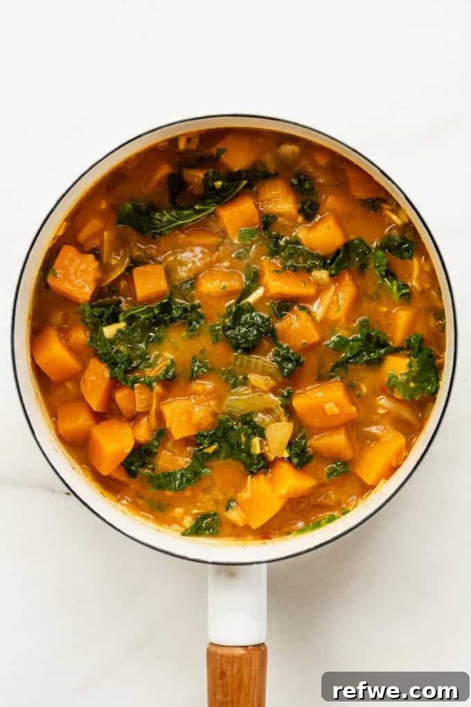 Velvet Squash Curry 9 A white pot showcasing a finished butternut squash and kale curry