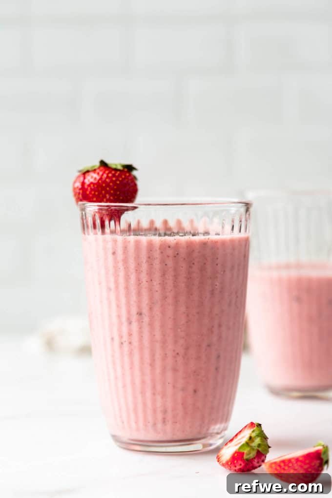 Nutrient-Rich Strawberry Banana Chia Seed Smoothie 8 A freshly blended strawberry chia seed smoothie in a glass, ready for enjoyment, highlighting its appealing texture and color.